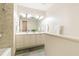 Bathroom features a double vanity, neutral tiling, and updated fixtures at 5114 N Ivy Ne Rd, Atlanta, GA 30342