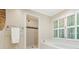 Bright bathroom featuring shower, tub, and window with natural light at 5114 N Ivy Ne Rd, Atlanta, GA 30342