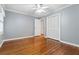 Bright bedroom featuring hardwood floors, crown molding, and a ceiling fan at 5114 N Ivy Ne Rd, Atlanta, GA 30342