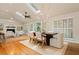 Sunlit dining area with skylight, fireplace, hardwood floors, and neutral tones, open to living spaces at 5114 N Ivy Ne Rd, Atlanta, GA 30342