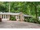 Attractive home with manicured shrubs, brick accents, and a welcoming front entrance, set on a driveway at 5114 N Ivy Ne Rd, Atlanta, GA 30342