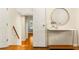 Hallway with an accent table, hardwood floors, and doors leading to other rooms at 5114 N Ivy Ne Rd, Atlanta, GA 30342