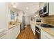 Modern kitchen featuring stainless steel appliances, granite countertops, and hardwood floors at 5114 N Ivy Ne Rd, Atlanta, GA 30342