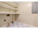 Functional laundry room with storage shelves and checkerboard flooring at 5114 N Ivy Ne Rd, Atlanta, GA 30342
