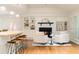 Open-concept living area with a fireplace, bar counter and hardwood floors, blending comfort and style at 5114 N Ivy Ne Rd, Atlanta, GA 30342