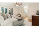 Comfortable main bedroom with ceiling fan, access to balcony, and ensuite bathroom at 5114 N Ivy Ne Rd, Atlanta, GA 30342