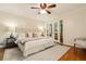 Well-lit main bedroom featuring a ceiling fan, rug, and access to the outdoors at 5114 N Ivy Ne Rd, Atlanta, GA 30342