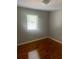Bright bedroom with wood-look floors, neutral walls, and a window offering natural light at 561 Formwalt Sw St # 7, Atlanta, GA 30312