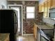 Modern kitchen featuring granite countertops, stainless appliances, and brick accent wall at 561 Formwalt Sw St # 7, Atlanta, GA 30312