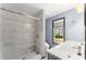 Beautiful bathroom boasts marble tiled shower, hexagonal floor tiles, and dual sinks at 1902 Memorial Se Dr, Atlanta, GA 30317