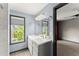 Modern bathroom featuring double sink vanity, stylish mirror, and window for natural light at 1902 Memorial Se Dr, Atlanta, GA 30317
