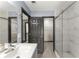 Spacious bathroom showcasing double sinks, glass shower, and doorways to walk-in closets at 1902 Memorial Se Dr, Atlanta, GA 30317
