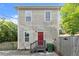 Home featuring faded gray siding, a red door, and fenced backyard at 1902 Memorial Se Dr, Atlanta, GA 30317