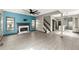 Open-concept living room with a marble fireplace, hardwood floors, and abundant natural light at 1902 Memorial Se Dr, Atlanta, GA 30317