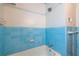 Bathroom featuring blue tile walls, shower head, and bath with classic fixtures at 3020 Washington Rd, East Point, GA 30344