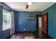 Bedroom with wood floors, blue walls, and window providing natural light at 3020 Washington Rd, East Point, GA 30344