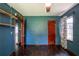 Bedroom with blue walls, wood floors, and natural light from the window at 3020 Washington Rd, East Point, GA 30344