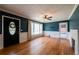 Inviting living room with hardwood floors, a ceiling fan, fireplace, and a decorative front door at 3020 Washington Rd, East Point, GA 30344
