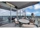 The covered balcony has an outdoor table and chairs overlooking the city at 3344 Peachtree Ne Rd # 3504, Atlanta, GA 30326