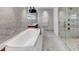 Luxury bathroom with a marble tub, sleek faucet, and spacious shower at 3344 Peachtree Ne Rd # 3504, Atlanta, GA 30326