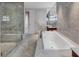Modern bathroom featuring a tub, walk-in shower, and double vanity with marble counters at 3344 Peachtree Ne Rd # 3504, Atlanta, GA 30326