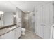 Bright bathroom with double doors, glass shower, and sink with granite countertop at 3344 Peachtree Ne Rd # 3504, Atlanta, GA 30326