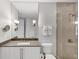 Bright bathroom features glass shower and a large mirror above the sink at 3344 Peachtree Ne Rd # 3504, Atlanta, GA 30326