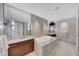 Spa-like bathroom boasts a marble tub, double vanity, and stylish lighting at 3344 Peachtree Ne Rd # 3504, Atlanta, GA 30326