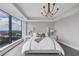 Bedroom featuring a bed with tufted headboard and floor to ceiling windows with incredible scenic views at 3344 Peachtree Ne Rd # 3504, Atlanta, GA 30326