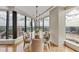 Elegant dining room with hardwood floors, chandelier, and floor-to-ceiling windows showcasing city views at 3344 Peachtree Ne Rd # 3504, Atlanta, GA 30326