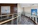 A hallway with glass railings and wood trim and paintings on the wall at 3344 Peachtree Ne Rd # 3504, Atlanta, GA 30326