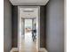 Hallway with neutral colors, decorative table and light fixture leading to a living room with great views at 3344 Peachtree Ne Rd # 3504, Atlanta, GA 30326