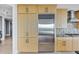 A modern kitchen features stainless steel appliances, maple cabinets and mosaic backsplash at 3344 Peachtree Ne Rd # 3504, Atlanta, GA 30326