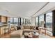 Open-concept living area with city skyline views, modern furniture, and a breakfast bar at 3344 Peachtree Ne Rd # 3504, Atlanta, GA 30326