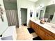 Bathroom with a double vanity, wood cabinets, a shower with a curtain, and neutral paint at 753 Summer Ridge Dr, Villa Rica, GA 30180