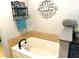 Bright bathroom featuring a white tub, decor, and a black iron decorative shelf at 753 Summer Ridge Dr, Villa Rica, GA 30180