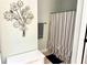 Bathroom area featuring vanity, decorative flower art, striped shower curtain, and muted green walls at 753 Summer Ridge Dr, Villa Rica, GA 30180