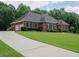 Lovely brick home with an attached two-car garage and well-kept grounds at 753 Summer Ridge Dr, Villa Rica, GA 30180