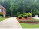 Well-manicured front yard with a brick driveway and a black wooden fence for added privacy at 753 Summer Ridge Dr, Villa Rica, GA 30180