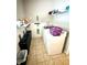 Laundry room including washer, dryer, shelving, trash cans, and tiled floor at 753 Summer Ridge Dr, Villa Rica, GA 30180