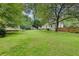 Wide expanse of green lawn in backyard with mature trees providing ample shade and privacy at 1131 Forrest Blvd, Decatur, GA 30030