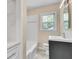 Bright bathroom with modern vanity, tile flooring, and bathtub with white tile surround at 1131 Forrest Blvd, Decatur, GA 30030