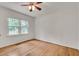 Bright bedroom with hardwood floors, a ceiling fan, and a large window at 1131 Forrest Blvd, Decatur, GA 30030