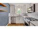 Modern kitchen with stainless steel appliances, white cabinets, and subway tile backsplash at 1131 Forrest Blvd, Decatur, GA 30030