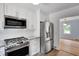 Well-equipped kitchen with stainless steel appliances, white cabinetry, and modern finishes at 1131 Forrest Blvd, Decatur, GA 30030
