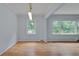 Inviting living room featuring hardwood floors, natural lighting, and a modern light fixture at 1131 Forrest Blvd, Decatur, GA 30030