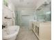 Chic bathroom with freestanding tub, glass shower, double vanity, and modern fixtures at 174 Pearl Se St, Atlanta, GA 30316