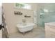 Elegant bathroom featuring a freestanding tub, glass enclosed shower, and stylish tile flooring at 174 Pearl Se St, Atlanta, GA 30316