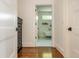 Bright hallway view to luxurious bathroom with freestanding tub and neutral wall coloring and marble floors at 174 Pearl Se St, Atlanta, GA 30316