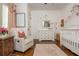 Charming Bedroom with floral accents, a glider, a crib, and soft lighting at 174 Pearl Se St, Atlanta, GA 30316